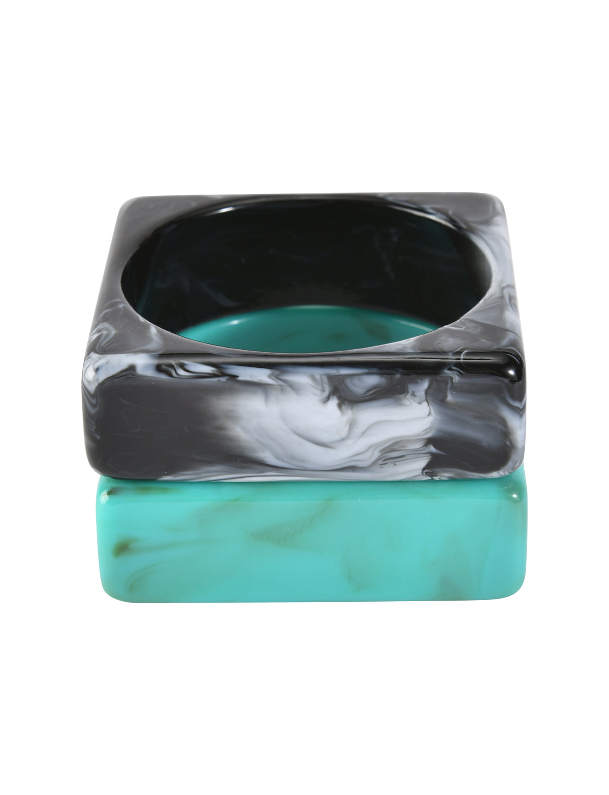 Two chunky square bangles from the AUGIE BANGLE SET - EMERALD AND BLACK by TIGERMIST: top is black marble with white marbling, bottom is emerald with light marbling—both have rounded inner edges.