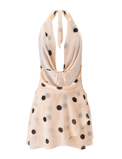 The LATHAN MINI DRESS by TIGERMIST is a light cream chiffon halter mini dress with large black polka dots, a deep V-neckline, open back, loose fit, and a playful tiered flounce skirt.