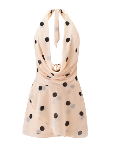 The LATHAN MINI DRESS - CREAM by TIGERMIST features cream chiffon with bold black polka dots, a halter neck, deep cowl neckline, open back, and asymmetrical hem—perfect for making a statement at your next event.