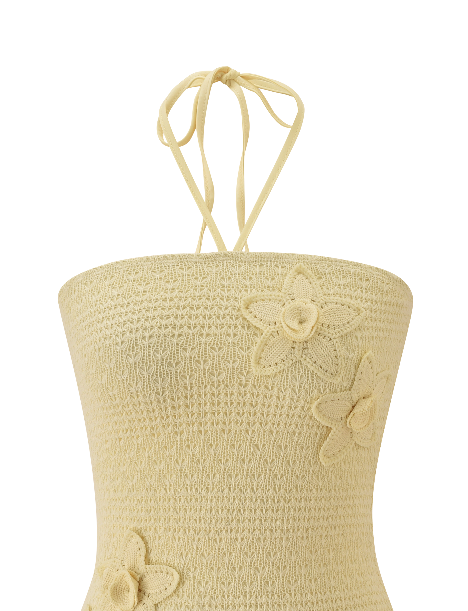 A close-up of the TIGERMIST KORRI DRESS in Butter, featuring delicate crochet floral appliques and thin halter neck ties against a plain white background.