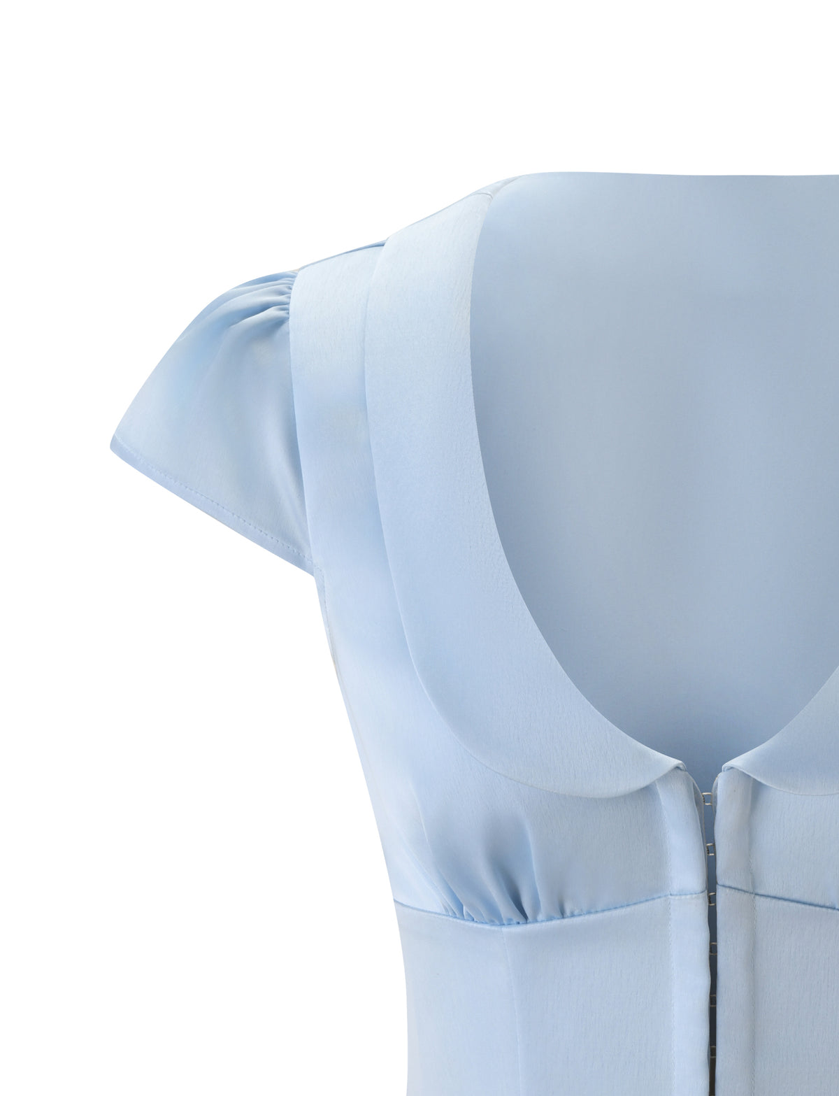 Close-up of the upper part of the MAURA TOP - SKY by TIGERMIST, featuring cap sleeves, a scooped neckline, visible stitching, and delicate princess seams against a white background.