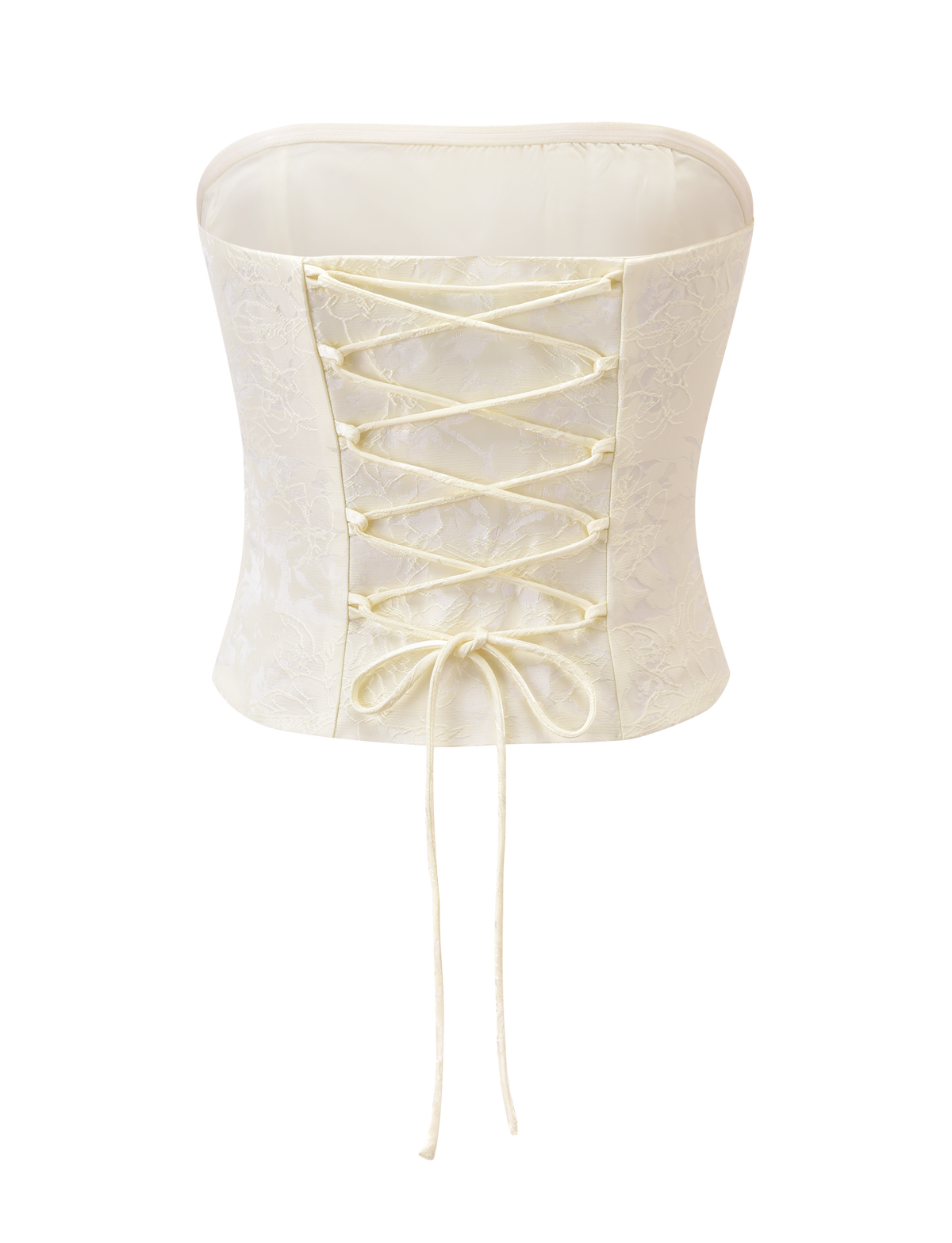 The LANIA CORSET TOP - CREAM by TIGERMIST features a subtle floral jacquard pattern, lace-up back, and cream ribbon bow, shown against a white background.