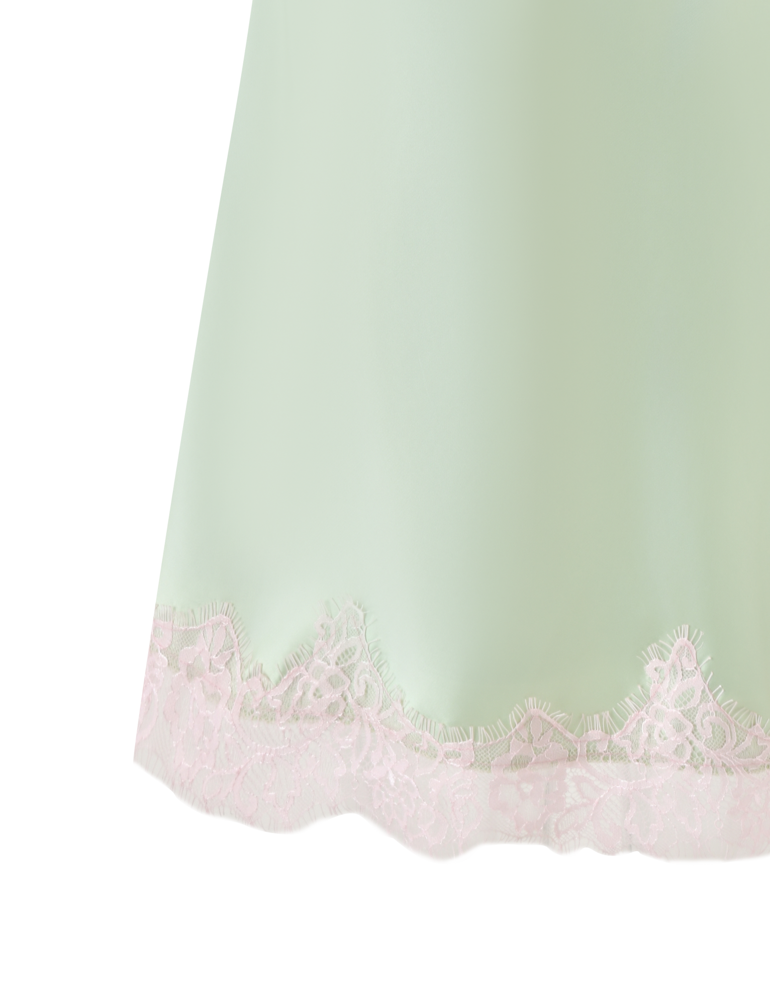 A close-up of the MILYANA MINI DRESS in pistachio by TIGERMIST, featuring light green fabric with a scalloped edge and pink lace hem against a white background.