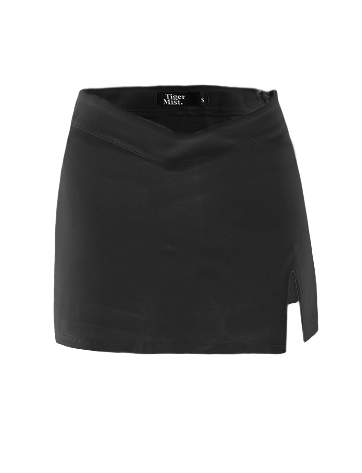 The DAPHNIE SKORT - BLACK is a mini skirt that showcases a stylish side slit on the right and an eye-catching v-cut waistline. Inside, you will find the label "TIGERMIST" marked with size "S".