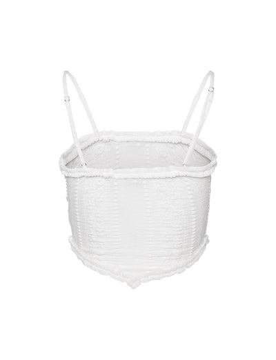 Introducing the SOPHA TWO PIECE TOP in white from TIGERMIST, a textured smocked crop top with spaghetti straps. It features a square neckline and elasticated detailing throughout for a stretchy fit, complemented by a slightly ruffled hem that adds a casual and stylish touch. Photographed against a plain white background.