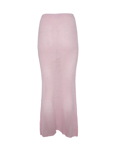The MACAULEY SKIRT in BABY PINK by TIGERMIST is a light pink, midi-length knitted skirt with a semi-sheer mesh design. It showcases a subtle diagonal pattern and features a fitted silhouette that gracefully flares out slightly at the hem.