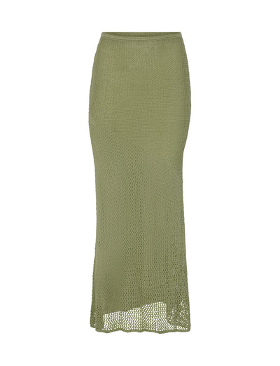 The MACAULEY SKIRT - GREEN from TIGERMIST is a full-length crochet skirt in a pastel green hue. It boasts a straight silhouette, high waist, and is crafted from textured, open-knit material. Its slightly uneven hemline enhances its casual, bohemian style.