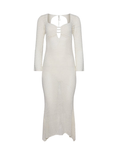 The MACAULEY DRESS - WHITE : CREAM by TIGERMIST is a white, long-sleeved, ankle-length knit dress with a form-fitting silhouette. It features a cut-out design at the neckline with two horizontal straps and a tie-up detail at the back of the neck. The semi-sheer material showcases an intricate geometric pattern.