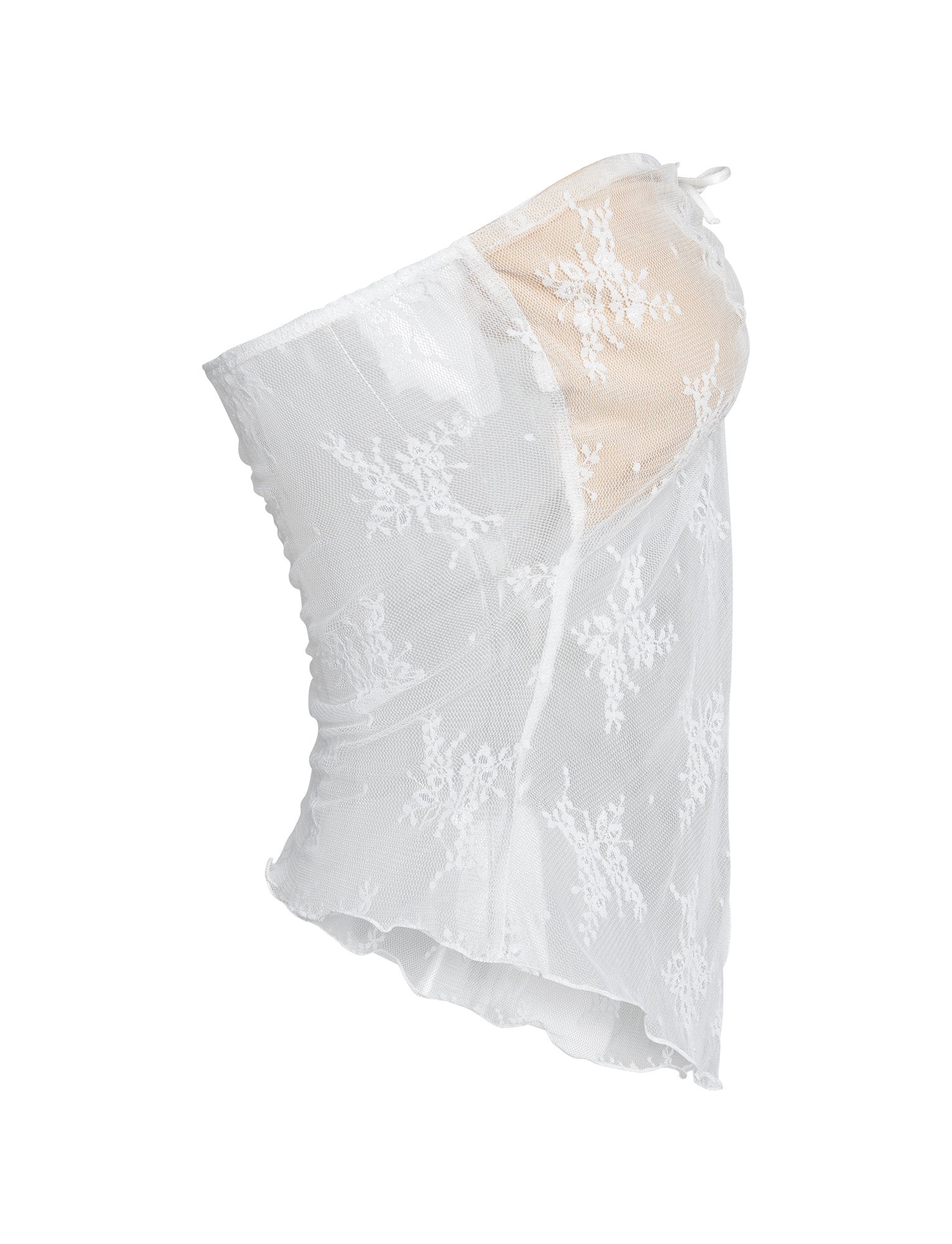 The Karolina Top by TigerMist is a white, asymmetrical, one-shoulder lace top featuring delicate floral patterns and a beige inner lining. The translucent lace overlay adds a stylish and elegant touch, while the uneven hem creates a unique and trendy silhouette.
