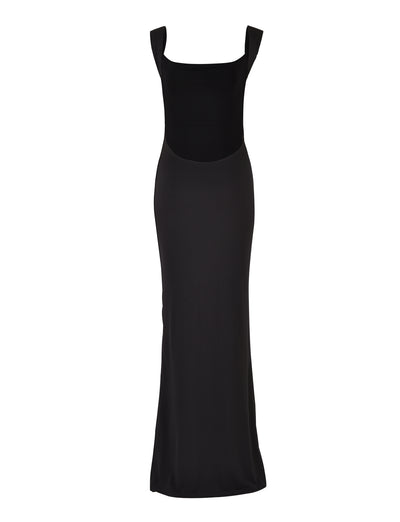 A sleek, full-length black evening gown from TIGERMIST, the MORANA DRESS - BLACK features a square neckline and wide shoulder straps. The dress boasts a fitted bodice that effortlessly transitions into a long, flowing skirt, creating an elegant and sophisticated silhouette.