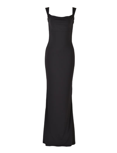 The MORANA DRESS - BLACK from TIGERMIST is a full-length evening gown featuring a fitted silhouette, sleeveless design, and cowl neckline. Its smooth, unembellished texture and floor-length hemline create an elegant and sophisticated look.