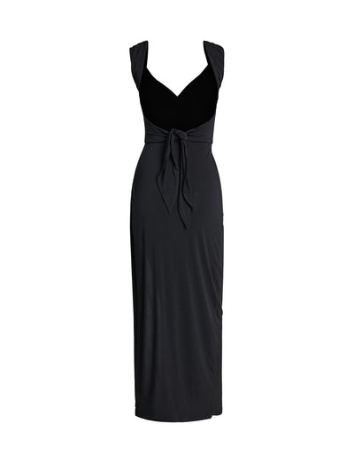 The JOSLIN MAXI DRESS - BLACK by TIGERMIST is a sleeveless dress with a V-neckline and a fitted silhouette. It features a knotted waist tie at the front, adding an elegant detail. The length extends to below the knee. The image shows the dress on a plain white background.